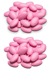 Pink vitamin pills isolated on white background (with shadow).
