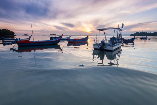 Sunrise and Sunset with by the beach with a boat in Penang Malaysia