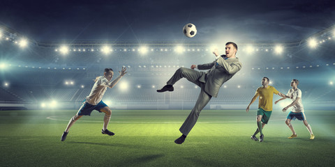 Businessman and players fighting for ball