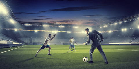 Businessman and player fighting for ball