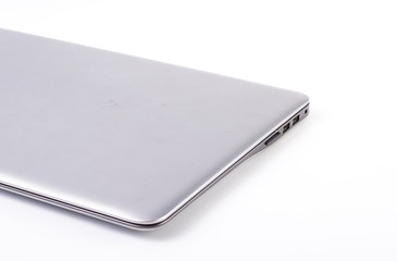 closed silver laptop isolated on pure white with large copy space