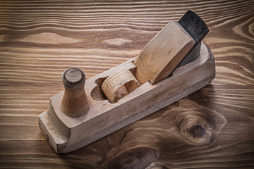 Shaving plane on vintage wooden board construction concept