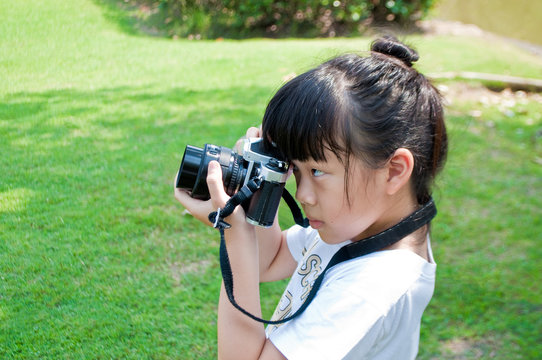 Little girl take photograph outdoor