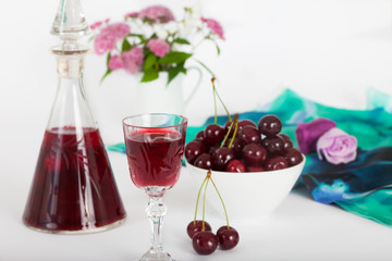  Cherry liqueur in crystal glasses and sour cherries