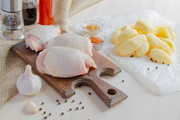 Chicken thighs. Spice. Chili pepper, soy sauce, pepper and peeled potatoes