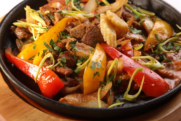 meat with vegetables on hot frying-pan