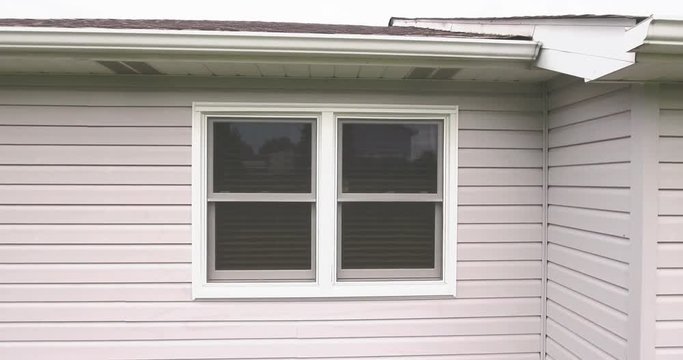 A drone drops outside a window and tries to spy into a home as the owner shuts the blinds.  	