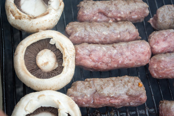 Grilling cevapi with mushrooms