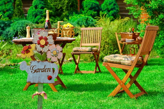 Sign Garden On The Wooden Plate And Wooden Outdoor Furniture