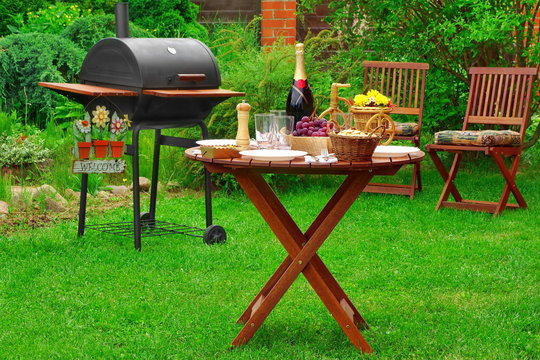 Summer Barbecue Family Party Scene With Grill On   Backyard Gard