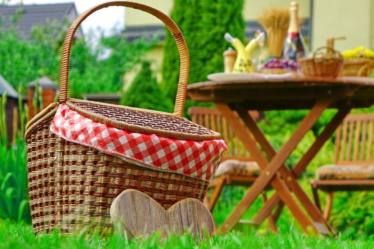Close-up Of Picnic Basket With Checkered Cloth On The Lawn
