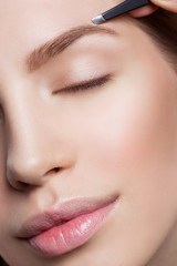 Fototapeta premium Woman correcting eyebrows form