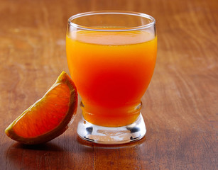 Orange juice  isolated on a wooden background