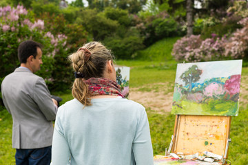 Naklejka premium Professional artists evaluating their work in the open air