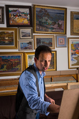 Serious male artist painting his picture
