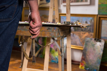 Male painter hand holding a paintbrush