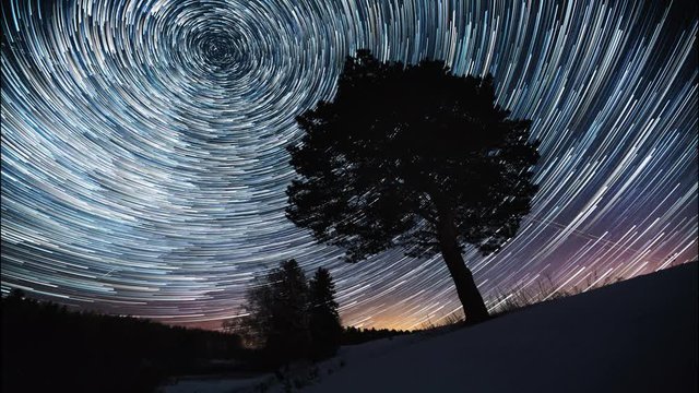 Starry sky time lapse with the star trails like comets