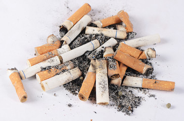 Cigarette butts amid the ashes