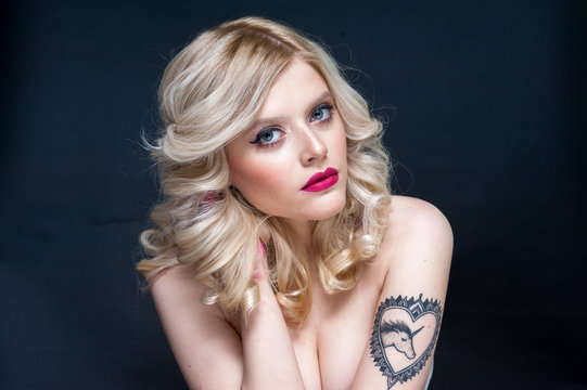 Unretouched studio beauty portrait of a blonde girl