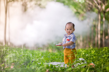thai baby playing on grass in park