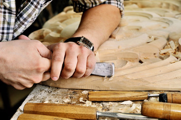 carvers Hands work with chisel in workshop