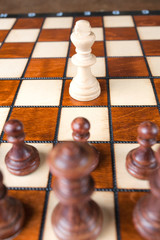 Chess one white king against black figures success concept.