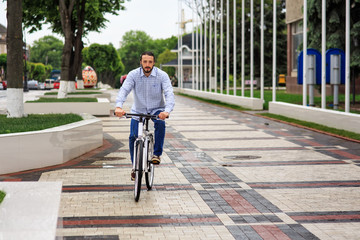 young hipster man with fixed gear bike on city street