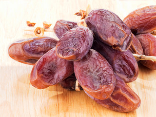 sweet dry date fruit isolated on wood