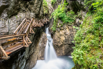 Wooden boardwalk leads through a tight canyon over whitewater, Sigmund Thun Klamm, Austria