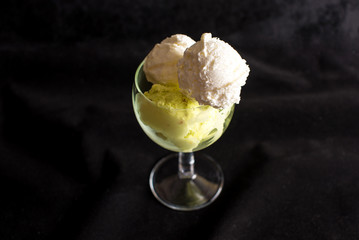 Vanilla and pistachio ice cream in a glass
