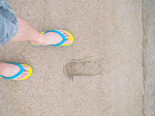 human bare feet standing on the sandal footware