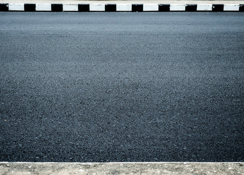 dark and rough asphalt surface in the road