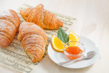 Croissants and orange marmalade. French breakfast