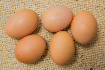  raw eggs on sackcloth background