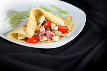 warm salad with ham wrapped in a pancake