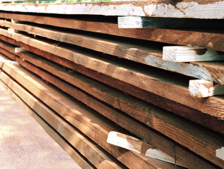 Unplaned thick planks covered with antiseptic preparation