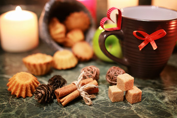 night cup of tea with candle and apple