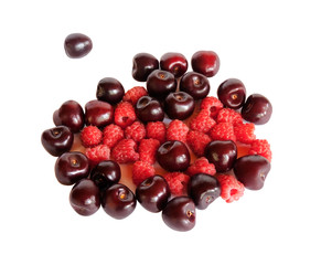 Ripe cherries and raspberries isolated on white background