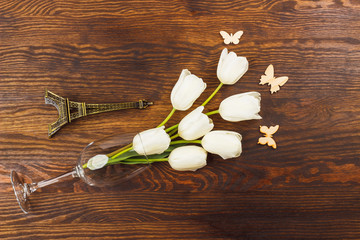 Wineglass with tulips and miniaturized Eiffel tower