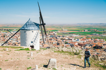 Man visiting traditional spanish windmills, Toledo, Spain