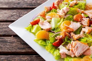 Fresh Orange Salmon salad with honey, tomatoes, onion, mandarin. healthy food concept