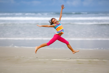 Girl jumping on the beach