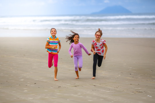 Friends running on the beach