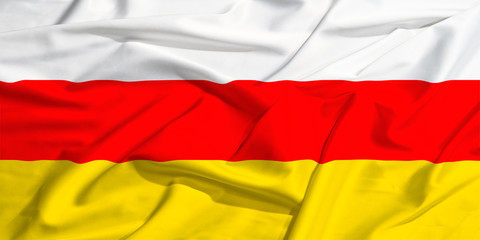 Naklejka premium waving flag of South Ossetia on a silk bright drape