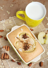 Homemade apple cake and yellow cup of milk, closeup