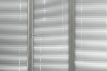 grey horizontal jalousie in the office window