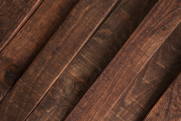 Diagonal dark wooden texture, background brown old wood planks.