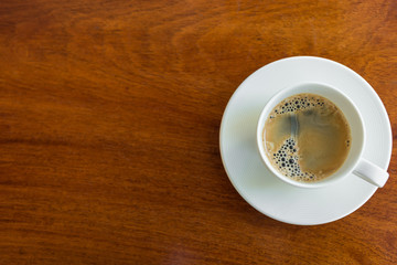Espresso cup on a wood table.