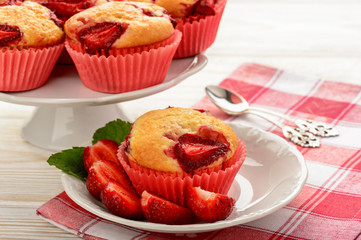 Strawberry muffins on the white plate. 