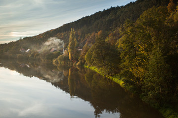 Naklejka premium Village near forest and river